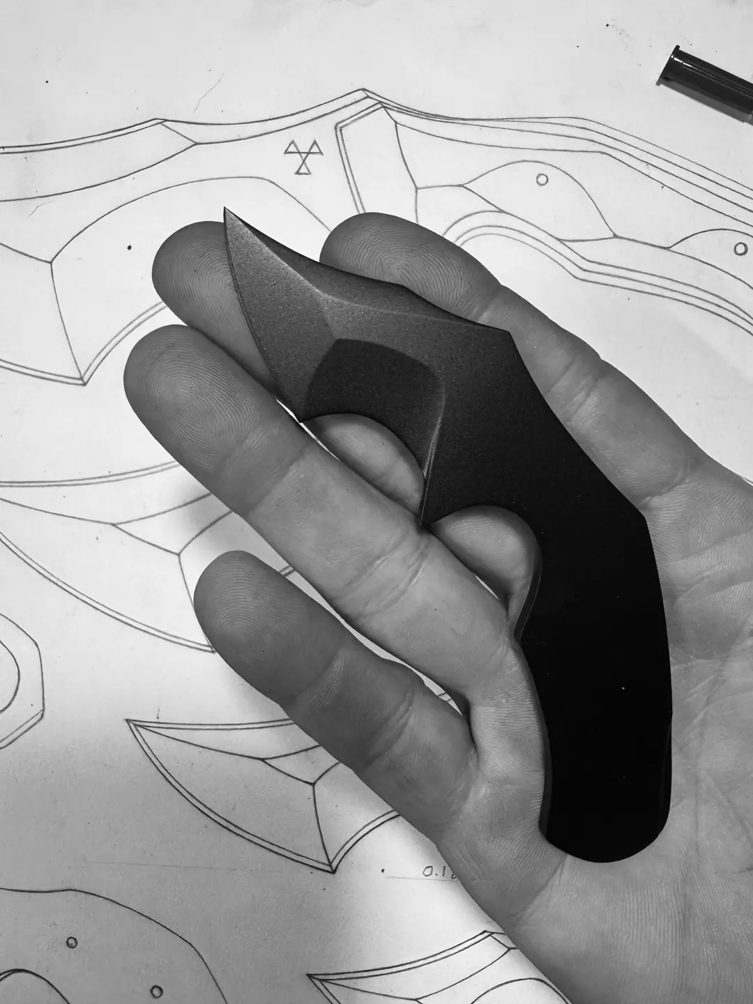 Mini Crusader prototype held over Jonathan Harrington’s original knife drawings